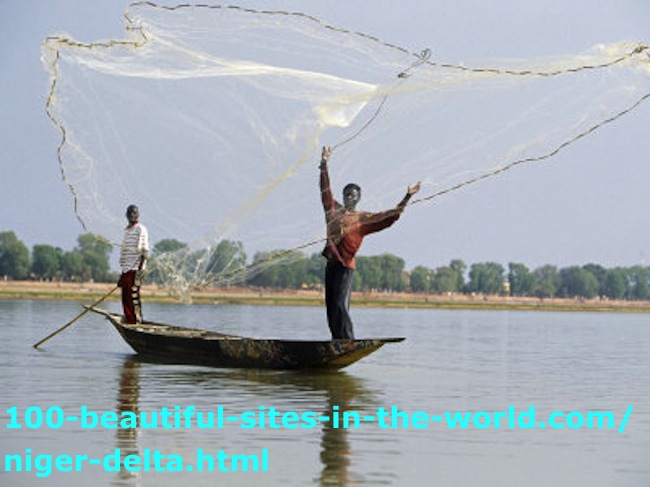 The Niger Delta: A Fisherman with His Colleague on a Boat Casting his Net.
